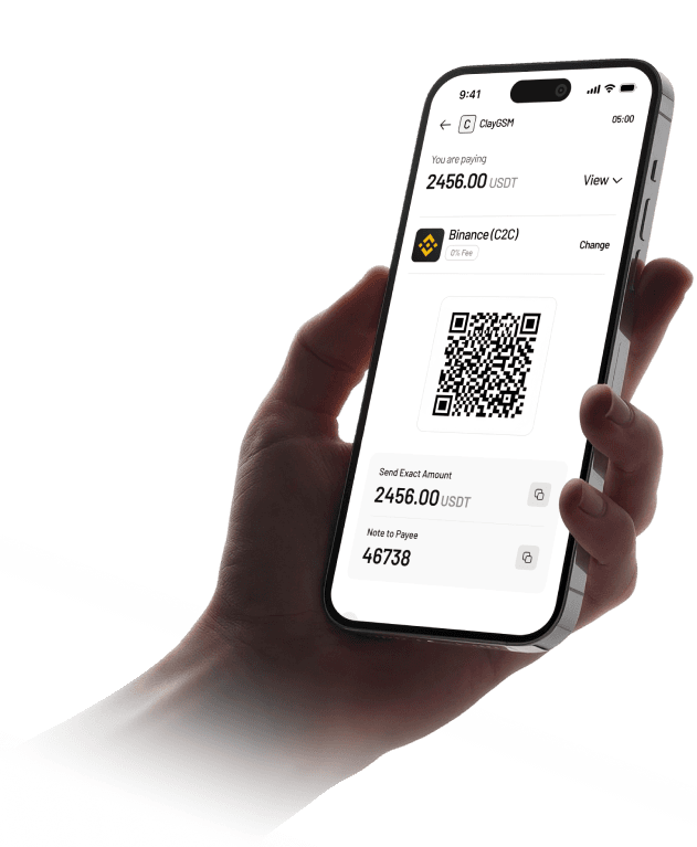 Hand holding a phone showing a GSM PAY USDT payment screen with a QR code